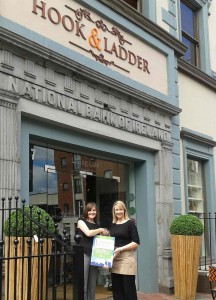 Pictured: Manager of Hook & Ladder, Aisling Meehan, being presented with the Award by Maura O’Neill of Limerick Tidy Towns outside the café.