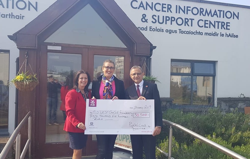 Meg Wiley Curran pictured presenting her check to LisaTracey and Professor Gupta of the Mid Western Cancer Foundation