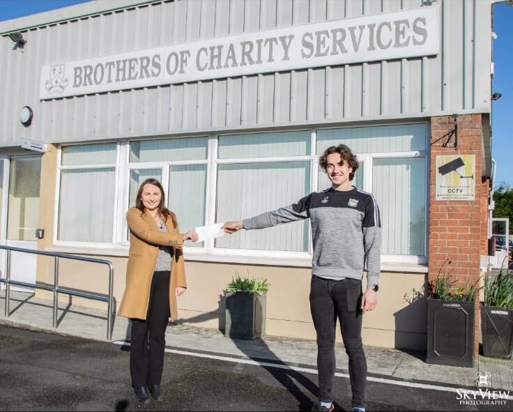 Newcastle West GAA club member Cian Sheahan pictured above with a representative from the Brothers of Charity