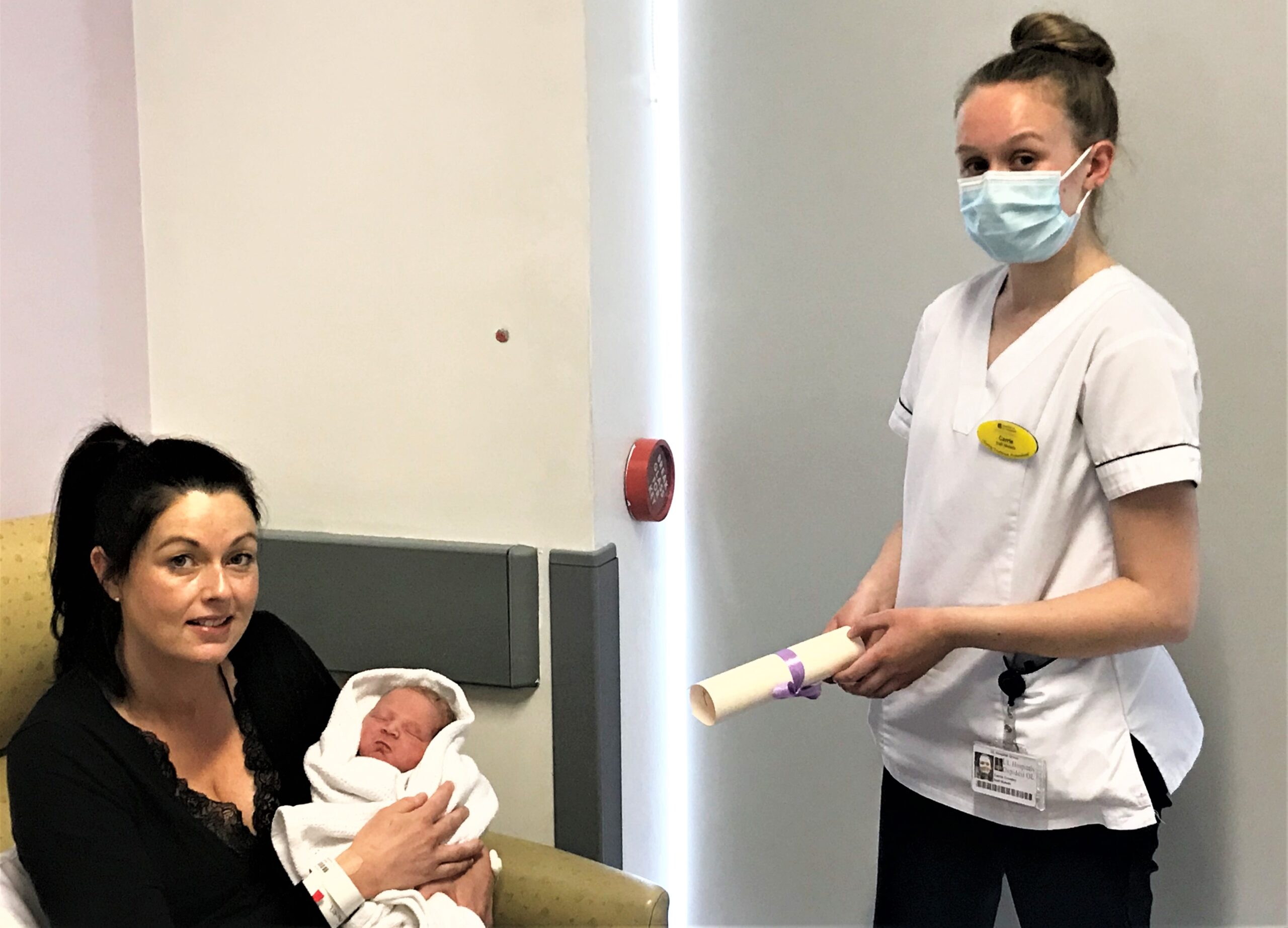 International Day of the Midwife - Joanne Ahern and her infant son, Evan, who was born at University Maternity Hospital Limerick at 00.57am on Wednesday May 5th, 2021, International Day of the Midwife, receiving a special commemorative certificate from UMHL Staff Midwife, Carrie Crowley.