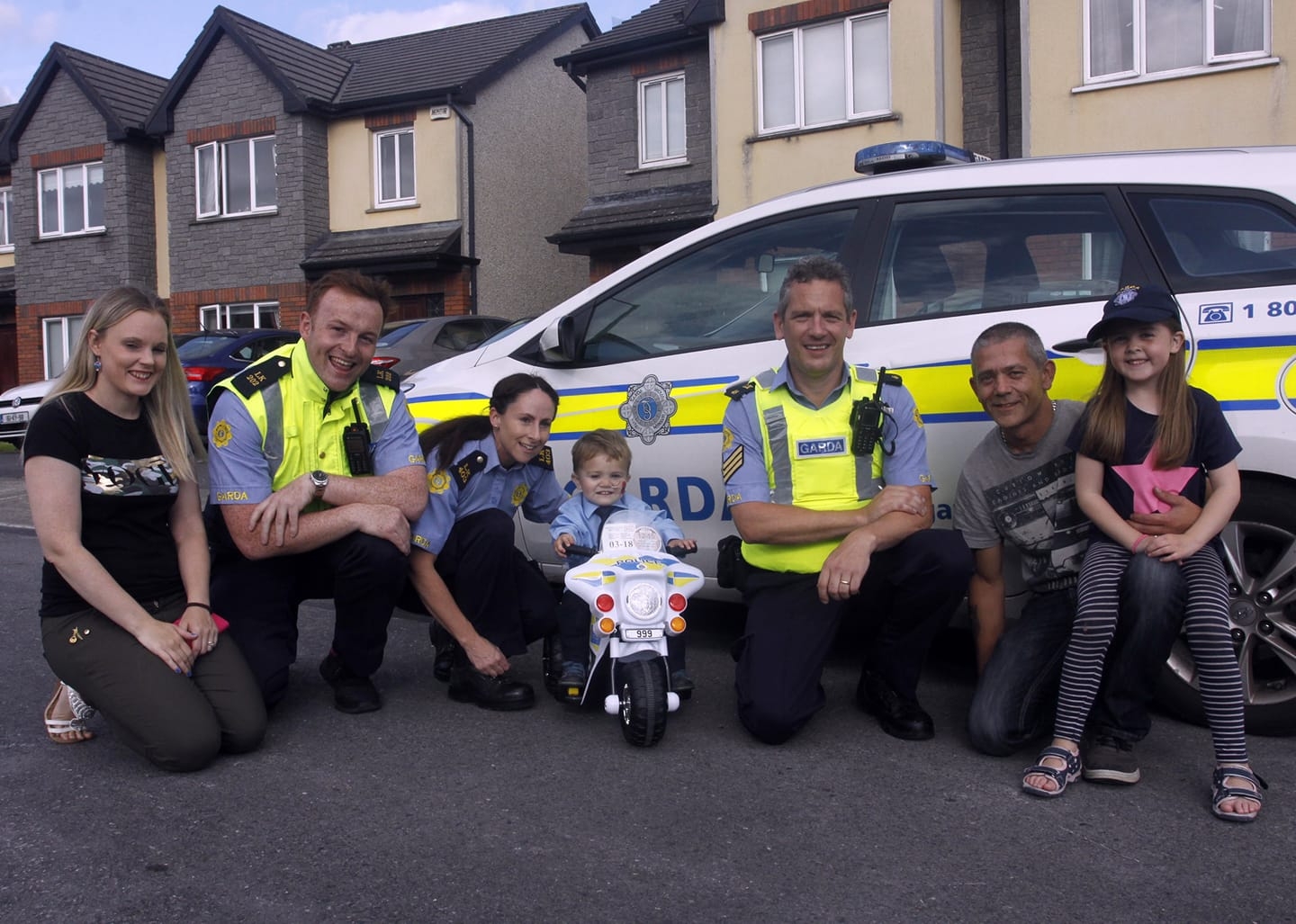 Una Quish (far left) pictured in 2019 with Gardai and family, provides round-the-clock care for her son, four-year-old Noah.