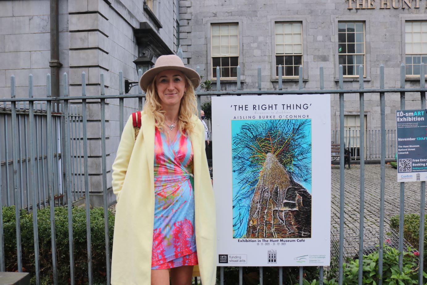 Aisling Burke O Connor with a poster for her exhibition ‘The Right Thing’ outside The Hunt Museum