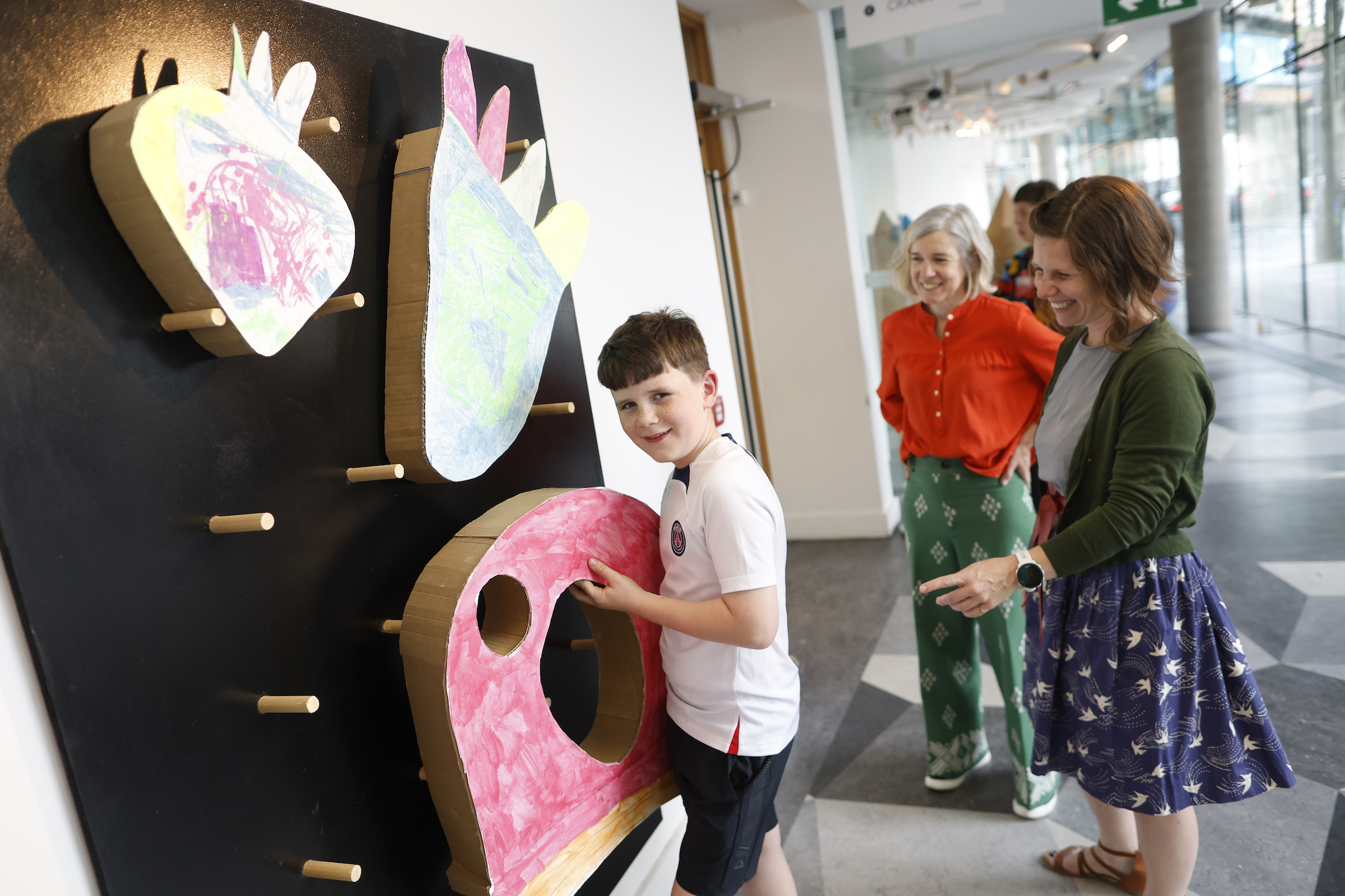 Rowan Murphy with his mum, Helium Arts artist Chelsea Canavan, who are from Limerick, with Monica Flynn, curator with Helium Arts. Photo credit: Julien Behal