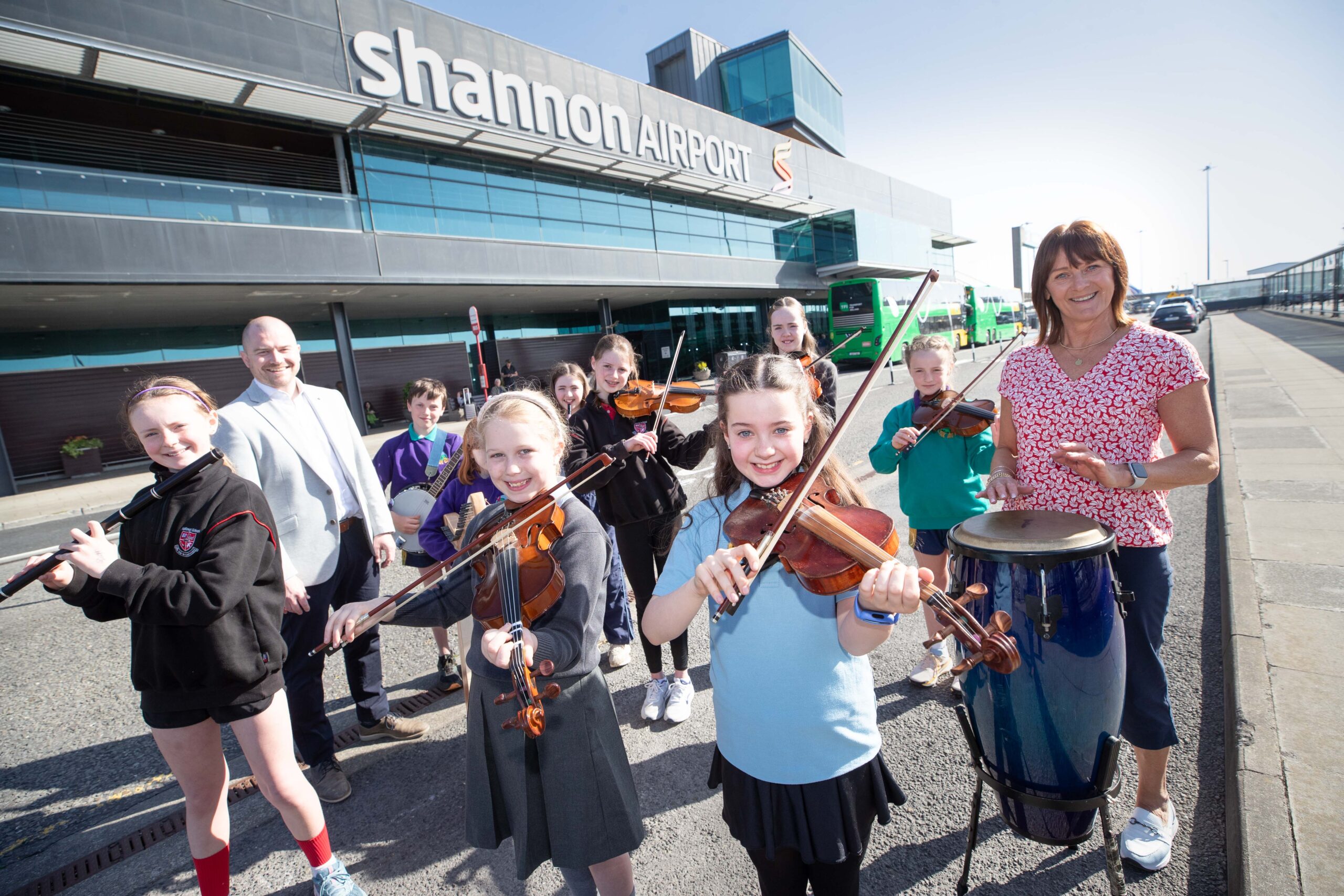 Niall Kearns, Airport Director and Claire Corry, Facilities Manager Shannon Airport along with Hannah Mangan, Ennis NS, Cillian Fahy, Knockanean NS, Laoise Chaplin, Sixmilebridge NS,Claire Reidy, Millford NS, AoibhinMcCarthy, Sixmilebridge NS , Sophie O'Connell, Sixmilebridge NS, Laoise Taylor, Milford National School, and Katelyn Cullinan, Knockanean NS taking part in the School Bands Spectacular Takes Flight at Shannon Airport as 200 Students Perform for Passengers on Thursday. Photograph by Eamon Ward Thursday 10th April 2025: Over 160 primary school students from Clare and Limerick took to the stage at Shannon Airport for a musical school band spectacular that had passengers and staff on their toes in the terminal building. Students from County Clare primary schools - Ennis National School, St. Fiannachta's National School (Sixmilebridge) and Knockanean National School, and from Milford National School (Limerick), gathered at the airport terminal for the reinstatement of the annual Schools Band Spectacular. This event, which had been a tradition for seven consecutive years before the Covid-19 pandemic, saw school bands perform at the airport. Photograph by Eamon Ward