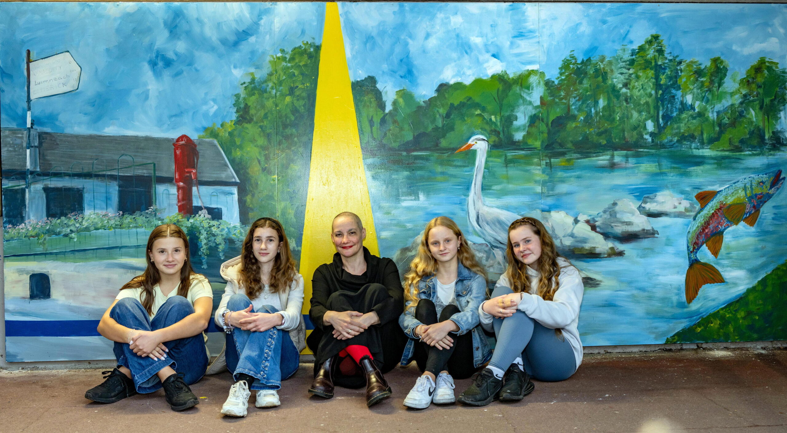 Pictured at the unveiling of a new art piece on the Iarnród Éireann network unveiled at Castleconnell Train Station, Limerick, as part of Síolta Glasa AR Trail initiative: The Heritage Line, Linking History, Rail and Climate Solutions is Ennis based artist Ana Colomer with some of the children from Castleconnell National School who helped in the project, from left, Hanna Szcepanik, Emilia Mazur, Artist Ana Colomer, Gabriella Golabek and Isobel Golabek, The creative and climate action collaboration between Iarnród Éireann, Castleconnell Tidy Towns and Artist Ana Colomer, the mural merges art, education and Augmented Reality (AR) elements, created by Professor Mark Marshall, from the University of Limerick. Photo by Don MacMonagle Issued on bahalf of Irish Rail - PR Photo Iarnród Éireann Press Release New Creative and Climate Action Community Art Project unveiled at Castleconnell Railway Station A new art piece on the Iarnród Éireann network has been unveiled at Castleconnell Train Station, Limerick, as part of Síolta Glasa AR Trail initiative: The Heritage Line, Linking History, Rail and Climate Solutions A creative and climate action collaboration between Iarnród Éireann, Castleconnell Tidy Towns and Artist Ana Colomer, the mural merges art, education and Augmented Reality (AR) elements, created by Professor Mark Marshall, from the University of Limerick. The Station is the starting point for an AR trail of six stops highlighting historical or natural landmarks within the beautiful heritage village of Castleconnell. Each stop features a short green video, hand drawn animations of native plants or animals, and interactive text designed to deepen understanding of biodiversity and sustainability.Through funding provided by Iarnród Éireann, a deeper experience and direct community involvement was provided through creative biodiversity workshops, including local nature walks, with students of Castleconnell National School to co create the interactive mural for the railway station. The initiative is planting the seeds of environmental stewardship by linking community stories and history, nature and climate action solutions. The project has been co supported by Limerick City and County Council and Creative Ireland Climate Action fund, which encourages creativity to empower communities to take climate actions. Joanne Bissett, Iarnród Éireann Arts and Social Officer said ‘We are delighted to unveil the latest art piece on our network and have worked with Ana Colomer, Castleconnell TT and the students of Castleconnell NS on this project. With the assistance of our Station Manager and Building and Facilities Department, we have utilised our station space in a new way to highlight the power of art as a visual for heritage and community. It also demonstrate how different groups can work together for positive climate action’ Castleconnell Tidy Towns said ‘We are overjoyed with the outcome of the project that highlights Castleconnell Train Station and public transport as an option for residents to reduce their carbon footprint. Creative Ana Colmer, worked with Castleconnell NS to create a mural that combined physical art and digital technology to encourage and nudge the community to be more sustainable. A broad section of the community contributed to the development of the Heritage Line linking history Rail and Climate Solutions, a resource available to all the community. We would like to especially credit Ana and Mark Marshall from University of Limerick (UL) for helping us to bring this concept to life’ Full details on Síolta Glasa AR Trail initiative: The Heritage Line, Linking History, Rail and Climate Solutions be viewed at: https://www.castleconnellheritageline.com/ For more information, Contact: Joanne Bissett , Arts and Social Officer, Iarnród Éireann, Corporate Communications – Ph: 087 1736400