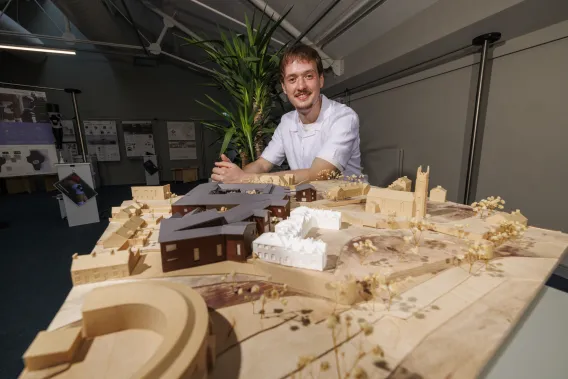 Paul Gallagher pictured with his 'miniature city' model that integrates a primary school with senior housing.