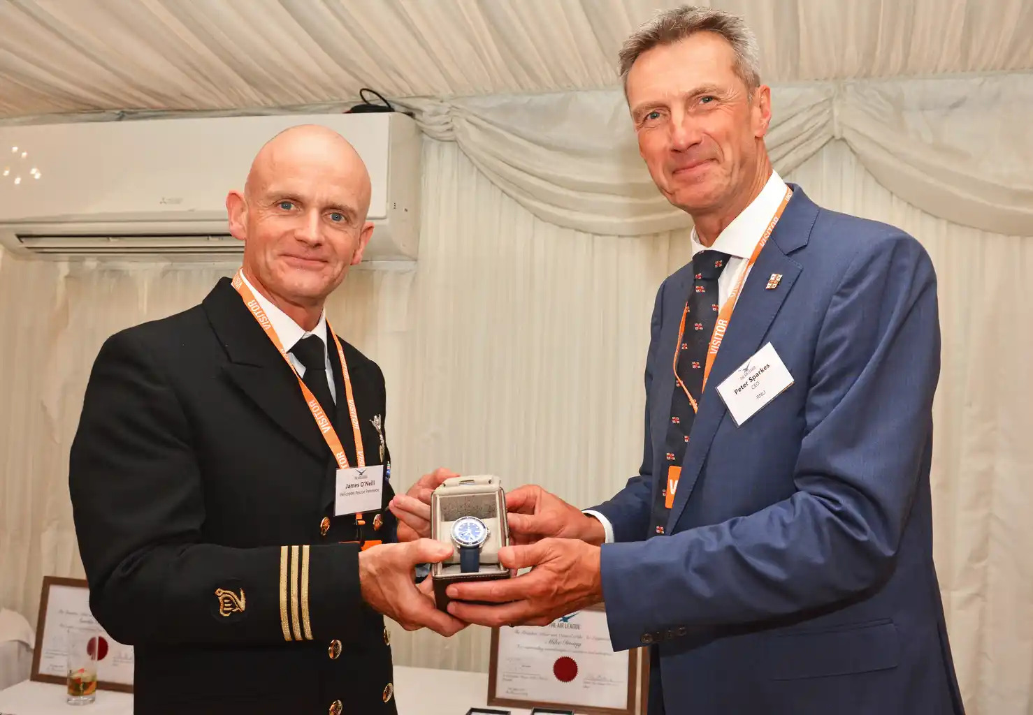Bristow Ireland Winch Paramedic James O'Neill (left) being presented with The Billy Deacon SAR Memorial Trophy, by RNLI CEO, Peter Sparkes