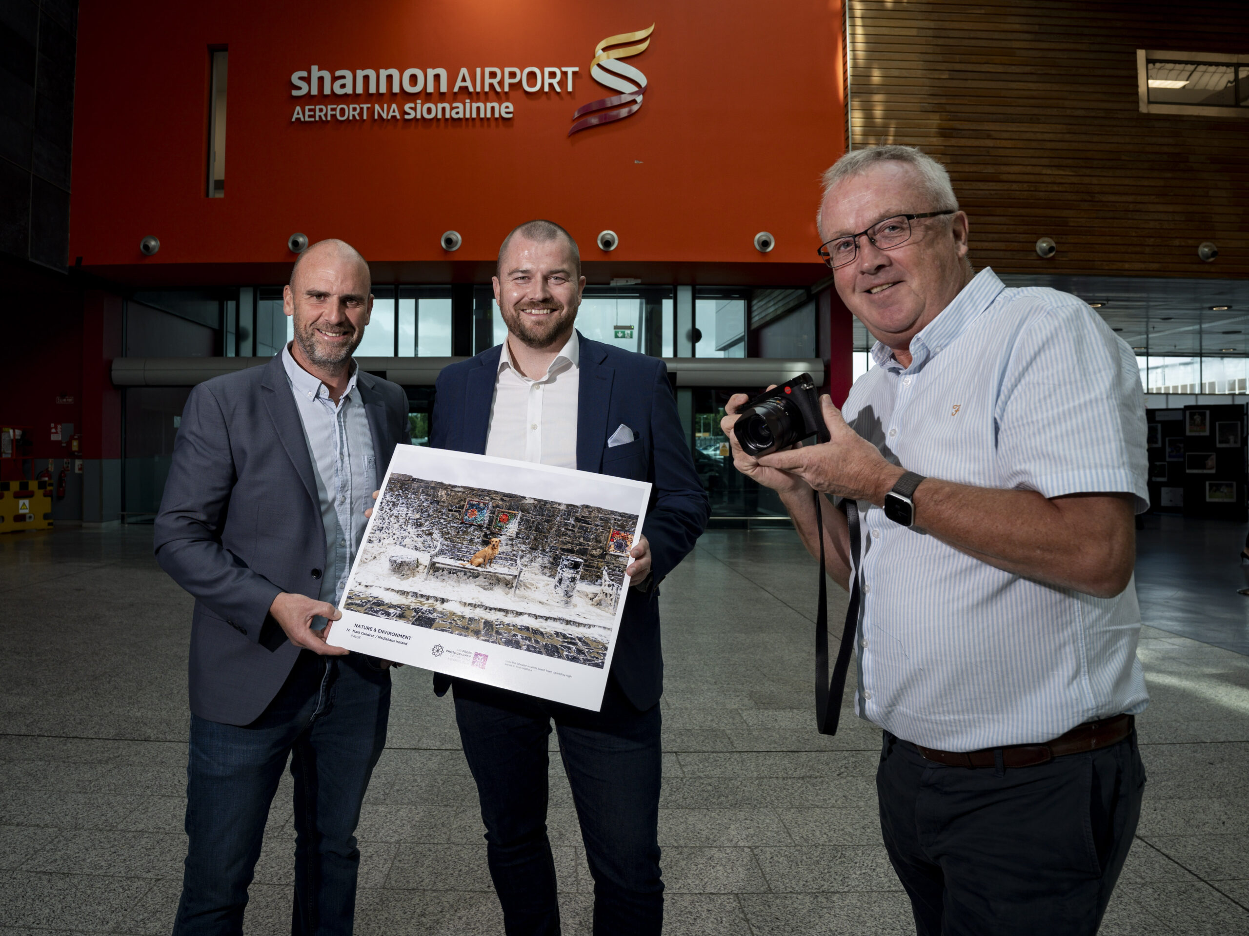 Mark Condren, 2026 Press Photographer of the year, Niall Kearns, Airport Director, Shannon Airport and Dan Linehan, President of Press Photographers of Ireland pictured as the Press Photographers of Ireland exhibition opens at Shannon Airport. Shannon Airport Welcomes Exhibition Capturing Ireland's Biggest Stories of 2025 Press Photographers Ireland CLG exhibition opens in Shannon Airport featuring more than 100 of the year's most powerful images. Monday 31st August 2026: The Shannon Airport Group is delighted to host this year’s Press Photographers Ireland CLG Exhibition, which opened today in the Check In area of Shannon Airport. The AIB Press Photographer of the Year Awards honour the finest in Irish press photography. This exhibition showcases all winning and shortlisted entries, featuring more than 100 striking photographs that capture Ireland's story throughout 2025 across eleven categories including News, Sport, Politics and Entertainment. Attending the launch was Mark Condren of Mediahuis Ireland, who was named AIB Press Photographer of the Year for a record seventh time, with awards across six categories. During the event, Mark shared insights from his distinguished photojournalism career and reflected on the stories behind some of his award-winning images. Welcoming the exhibition, Niall Kearns, Airport Director of Shannon Airport, said: "Press photographers play a vital role in documenting history as it happens, capturing images that stay with us long after the moment has passed. We are proud to host this remarkable exhibition at Shannon Airport, giving our passengers and visitors the opportunity to experience over 100 powerful photographs that defined Ireland in 2025. We are also delighted to welcome Mark Condren to Shannon today and to congratulate him and all the talented photographers whose exceptional work is featured in this exhibition." Dan Linehan, President of Press Photographers Ireland CLG, said: "The work on