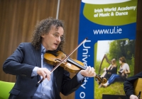 27/01/2016The University of Limerick names Clare fiddler Martin Hayes as its inaugural Irish World Academy Artist.Performing at the announcement is Irish World Academy Artist Martin Hayes.The University of Limerick has announced a new three-year arts patronage award through the Irish World Academy of Music and Dance. The award, entitled Irish World Academy Artist, University of Limerick will facilitate the creative process of selected artists across a three-year period through a budget of €60,000.The first artist to receive the award is Clare fiddler Martin Hayes who commences his three-year association with the Irish World Academy, University of Limerick in January 2016. Martin Hayes has been internationally acclaimed for bringing his local East Clare traditional fiddle style to a global audience through his many performances and recording. More recently he has formed the ensemble The Gloaming which has further pushed the boundaries of Irish traditional music in the field of ensemble playing that started with Sean Ó Riada’s (1930 – 1971) pioneering ensemble Ceóltóirí Chualainn in the 1960s. Hayes also acknowledges the significant influence of Dublin fiddler Tommie Potts (1912 – 1987) on his creative output.The Irish World Academy Artist at the University of Limerick will undertake a series of creative projects across the three-year span. Students of the Academy will have access to open workshops in the state-of-the-art Irish World Academy building on the banks of the river Shannon on the University Campus.(Speaking at the launch of the award) Professor Don Barry, President of the University said: “It is fitting that an artist of the stature of Martin Hayes should be the inaugural Irish World Academy Artist, given Martin’s unique contribution to our cultural life and the Irish World Academy’s vision for Ireland’s past, present and future.”On his appointment, Martin Hayes said: "I'm deeply honoured to be named the first Irish World Academy Artist at the University of Limerick and grateful for the opportunity this three year initiative affords me to explore the possibility of further musical collaboration in such a creative environment.” Professor Mícheál Ó Súílleabháin, Chair of Music and Founder Director of the Irish World Academy said: "The Irish World Academy Artist initiative is further evidence of the commitment of the University of Limerick to the Performing Arts at the highest level. That the first award goes to a local artist with a global reputation builds on the Irish World Academy record of linking the local with the global towards the mutual benefit of both.”Picture credit: Diarmuid Greene/Fusionshooters