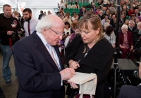 29.09.14         NO REPRO FEE
President of Ireland, Michael D Higgins has become the first recipient of the honour of Freedom of Limerick following a ceremony in Limerick city this afternoon (Monday).

President Higgins received the honour in front of almost 1000 members of the public in Limerickâs open air Milk Market.
Limerick City and County Council Chief Executive Conn Murray read aloud the text of the Scroll of Freedom before Cathaoirleach, Cllr Kevin Sheahan presented the ceremonial document to President Higgins. 
President of Ireland, Michael D. Higgins signs his autograph for Noreen Ryan, Castleconnell after he was conferred with the Freedom of Limerick. Picture: Alan Place/FusionShooters.