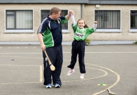04/06/2015
St Brigid's NS were awarded their 5th Green Flag and Limerick manager TJ Ryan and Limerick hurler Kevin Downes were on hand to help the students raise the flag.
Pictured during a hurling training session is Emily O'Callaghan-Smith, 1st class, along with hurling coach Mike Power, Claughaun GAA club.
St Brigid's NS, Singland, Limerick.
Picture credit: Diarmuid Greene